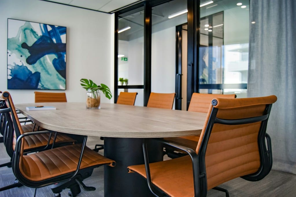 Finished conference room after an office move, with table, chairs, and glass walls ready for use
