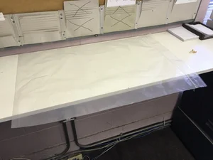 Large translucent protective sleeve on a work table